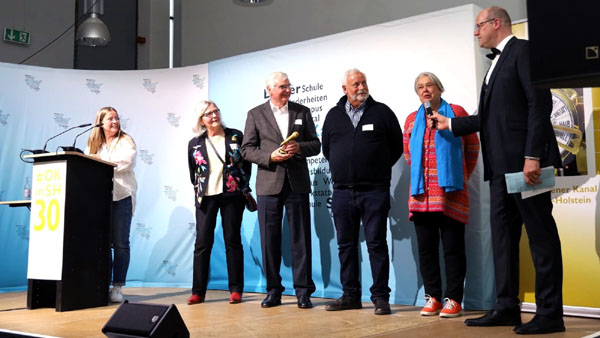 Kerstin Wehrmann (links) und Henning Fietze (rechts) übergaben die Auszeichnung an Maria Bommert, Fritz Toelsner, Rolf Fechner und Angelika Hartfelder vom Travemünde Journal. Foto: OK