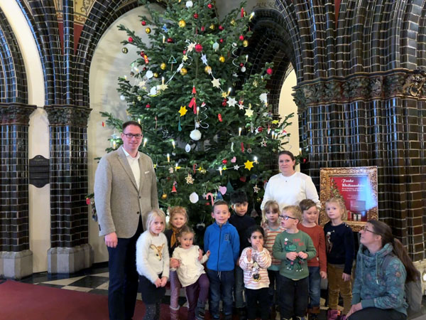 Din Kinder schmückten zusammen mit Bürgermeister Jan Lindenau den Weihnachtsbaum im Rathaus. Foto: HL